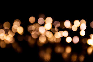 Abstract bokeh lights on a dark background. Christmas magical light, overlay or lens flare effect