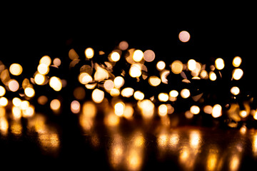 Abstract bokeh lights on a dark background. Christmas magical light, overlay or lens flare effect