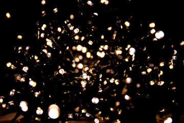 Abstract bokeh lights on a dark background. Christmas magical light, overlay or lens flare effect