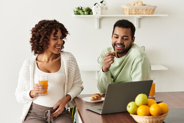 Happy couple enjoys a joyful moment together while preparing for their new arrival