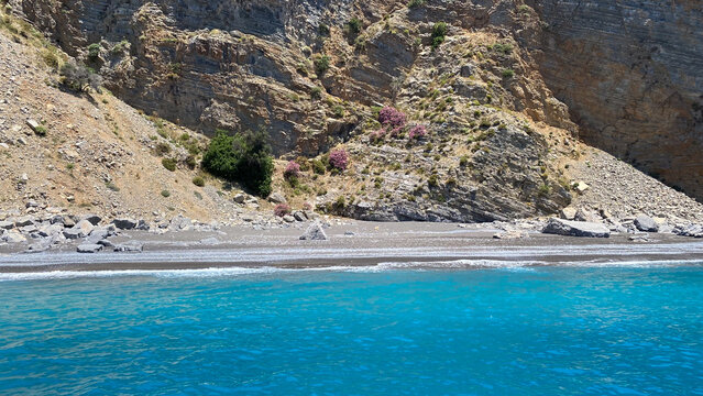 A view of a rocky beach with clear blue water