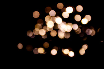 Abstract bokeh lights on a dark background. Christmas magical light, overlay or lens flare effect