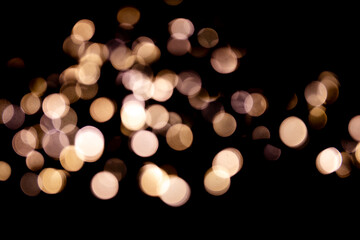 Abstract bokeh lights on a dark background. Christmas magical light, overlay or lens flare effect