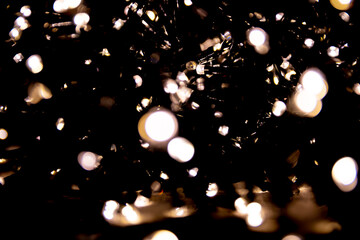 Abstract bokeh lights on a dark background. Christmas magical light, overlay or lens flare effect