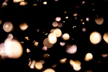 Abstract bokeh lights on a dark background. Christmas magical light, overlay or lens flare effect