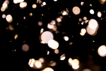 Abstract bokeh lights on a dark background. Christmas magical light, overlay or lens flare effect