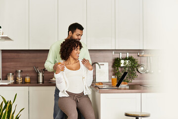 Couple sharing joyful moments together while expecting a new baby at home