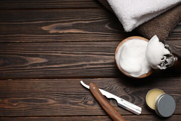 Different barber's tools on wooden background, flat lay. Space for text