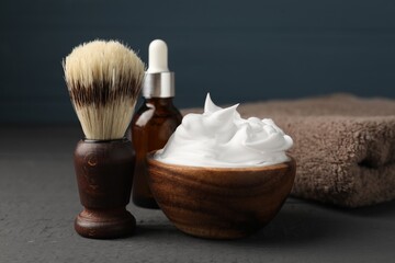 Different barber's tools on grey wooden table, closeup