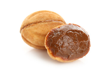 Delicious nut shaped cookies with boiled condensed milk isolated on white
