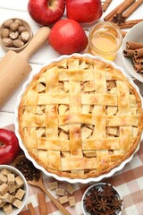 Delicious homemade pie, fresh apples and spices on white wooden table, flat lay