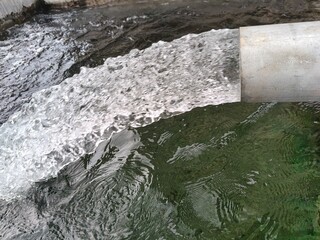 Close up shot of Water flow out of the pipe pumping.
