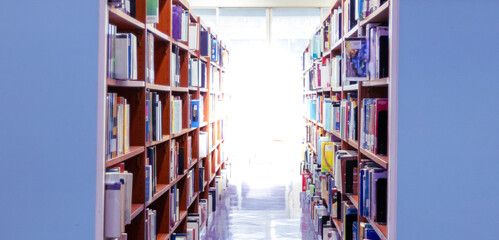 Library. Bookshelves with books and textbooks. Learning and education concept. Abstract blurred public library interior space. blurry room with bookshelves by defocused effect. use for background.