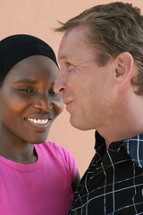 portrait , interracial couple, young african woman and white man, head and shoulders