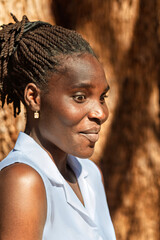portrait single young african woman with surprised demeanor expression , braids, dreadlocks hairstyle, head and shoulders