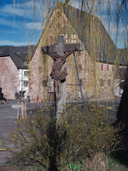 Stone Crucifix in Front of Historic Buildings