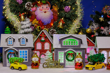 A beautiful Christmas village with yellow cars with Christmas trees on the roofs on each side