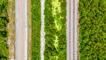 Aerial top down Bayou Swamp train tracks railway summer nature scene in rural Louisiana LA