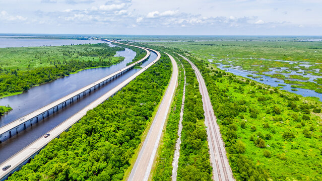 Aerial top down Bayou Swamp train tracks railway summer nature scene in rural Louisiana LA