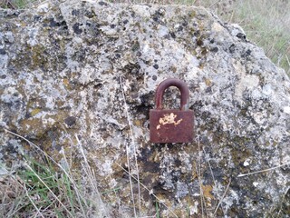 Rusty lock on natural stone