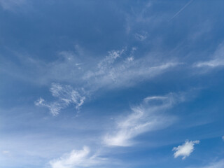 Serene Blue Sky with Scattered Clouds