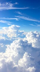 Stunning aerial view above fluffy white clouds in a vibrant blue sky.