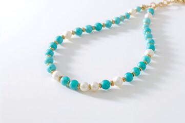 Exquisite handcrafted necklace featuring vibrant turquoise beads, lustrous white pearls, and delicate gold accents, perfect for adding a touch of elegance to any ensemble