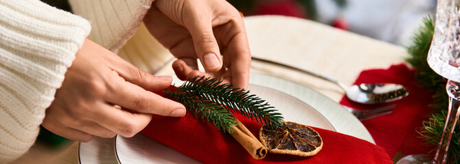 Creating a festive holiday table setting with natural decor elements for Christmas celebration