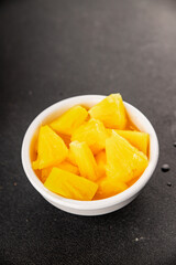 Pineapple canned chunks sweet fruit dessert tasty snack fresh delicious gourmet food background on the table rustic top view copy space keto and paleo diet vegetarian and vegan food