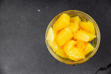 Pineapple canned chunks sweet fruit dessert tasty snack fresh delicious gourmet food background on the table rustic top view copy space keto and paleo diet vegetarian and vegan food