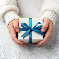 Small Christmas Gift With Blue Ribbon in Child’s Hands – Magical Winter Moment