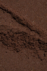 texture of ground brown herbal powder, macro