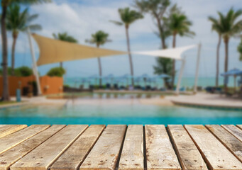 Wooden table top on the beach or sea. swimming pool Party on the beach  sunshine time concept.For montage product display or design key visual layout.View of copy space.