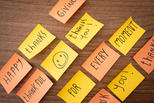 Positive and thankfull notes on a wooden background. Thanksgiving day