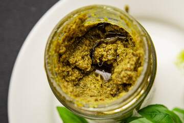 Pesto sauce basil, olive oil, parmesan, pine nuts, garlic natural product tasty snack fresh delicious gourmet food background on the table rustic top view copy space