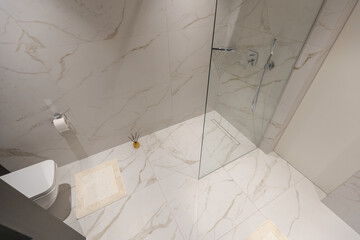 Amazing white marble master bathroom with large glass walk-in shower,