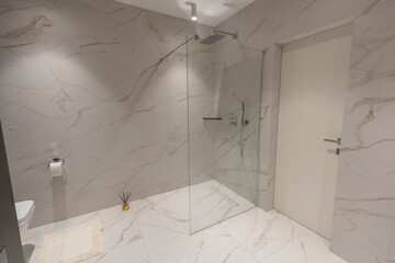 Amazing white marble master bathroom with large glass walk-in shower,