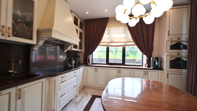 A bright kitchen with white cabinetry, marble floor, a round table, and brown curtains. The space feels modern and clean