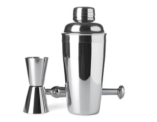 A shiny stainless steel cocktail shaker and jigger sit next to a mixing instrument against a clean white backdrop