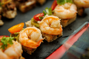 Shrimp appetizer on bread with tomato and guacamole