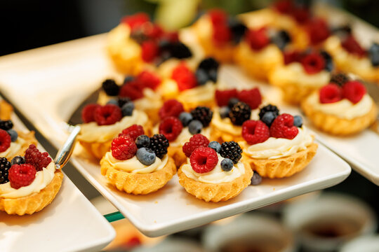 Mini fruit tartlets with cream and berries