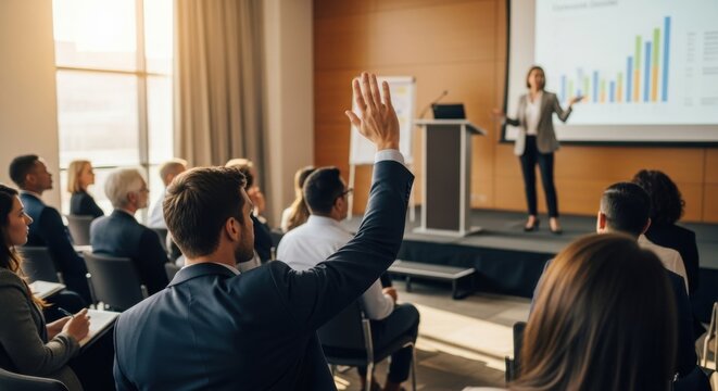 Business Presentation in Conference Room with Female Presenter Showing Graphs on Large Screen to Attentive Audience
