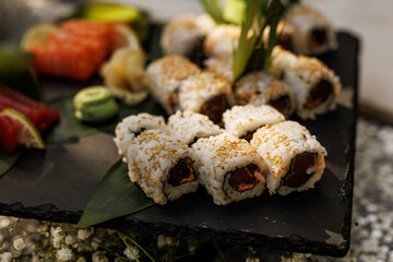 Assorted sushi rolls and nigiri on wooden platter