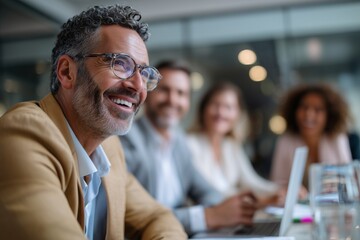 Happy middle-aged businessman smiling during meeting with diverse team in modern office. Professional corporate teamwork concept. Ideal for business ads, leadership, workplace visuals.