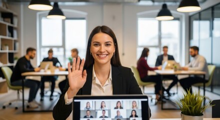 Business woman waving hand during a video conference call in a modern office. Hybrid work concept for remote team meeting. Corporate communication and virtual webinar technology.