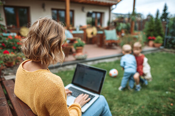 Wide shot of parent on beige bench with laptop and coffee, kids running on soft green lawn, warm sunlight, terracotta pots and plants nearby. Freedom, happiness, mindful outdoor life.
