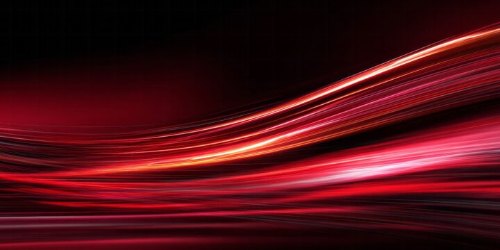Intense vibrant red light streaks flow dynamically across a dark background creating an abstract motion effect.