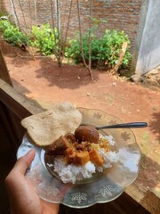 rice porridge with coconut milk served with several side dishes