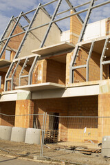 Urban building underway with scaffolding, Erecting residential structure amidst urban scaffolding...