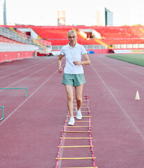 Fototapeta premium Portait of sports coach, children at stadium having althletics training. Portrait of athlete group, coaching and training at sport academy